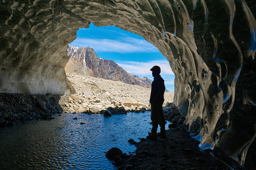 A hiker contemplates the interior of an ice cave located under the Universidad glacier (one of the largest in Chile), located in the central area of the country, in the O'Higgins region.