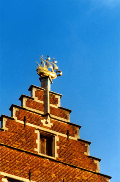 Sailboat weather vane against blue sky with copy space.