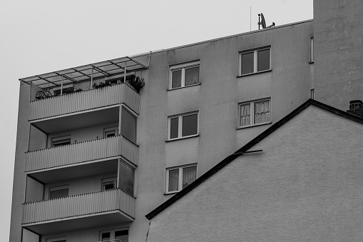 an apartment building in a city in black and white