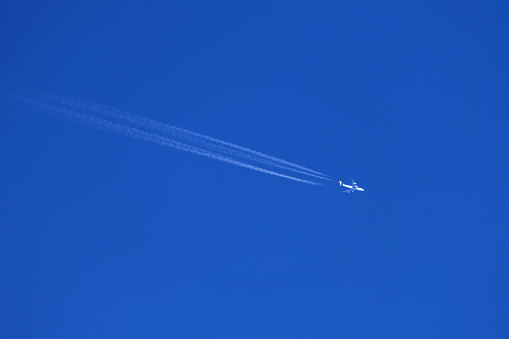 airplane trail in the clear blue sky
