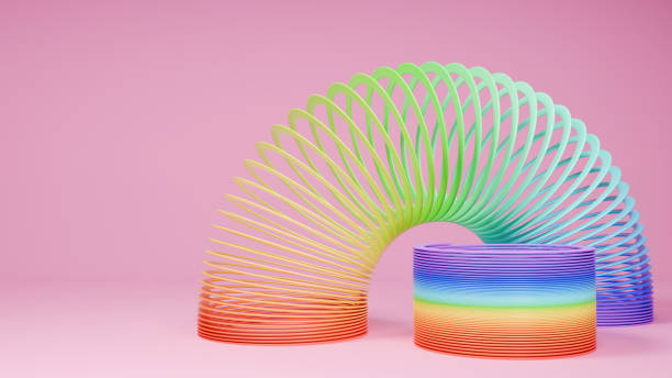 istock Slinky toys on pink background. Rainbow spring. 3D rendering. 1940382375
