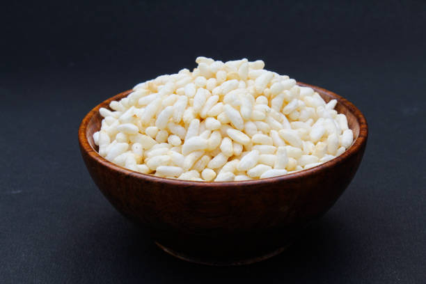 Puffed rice in a bowl on black background