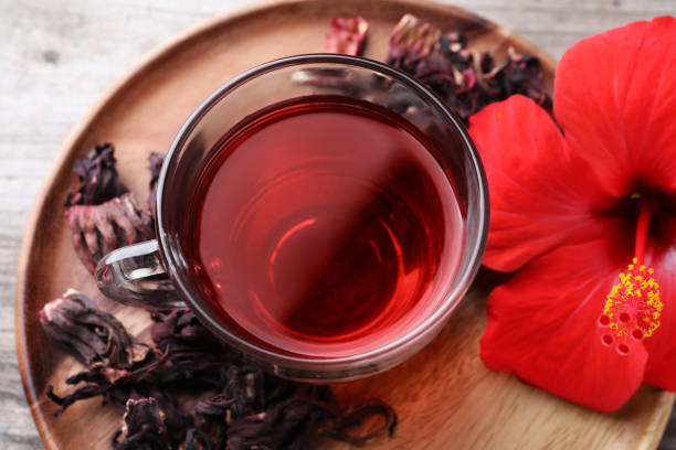 istock Delicious hibiscus tea and flowers on table, above view 1940391944