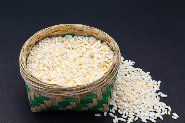 Puffed rice in a bamboo basket on black background