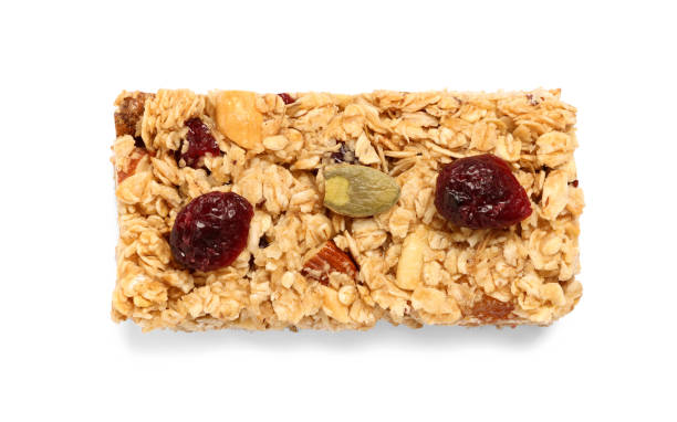 istock Tasty granola bar with berries isolated on white, top view 1940396507