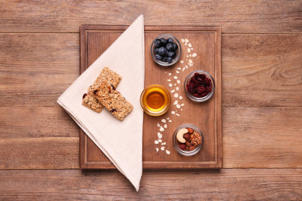 istock Tasty granola bars served on wooden table, top view 1940397555
