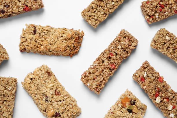 istock Tasty granola bars on white background, flat lay 1940398610