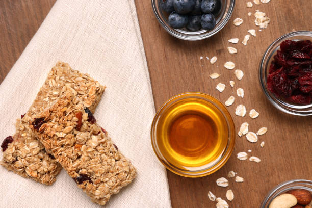 istock Tasty granola bars served on wooden table, flat lay 1940399657
