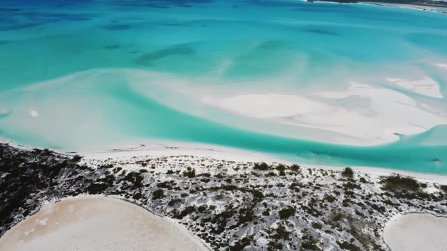 Beautiful Aerial View of the Exumas, Bahamas near George Town with many boats and Sailing Yachts Anchored. White sandy beach and turquoise Water.
