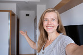 Happy woman showing her hotel room taking selfie