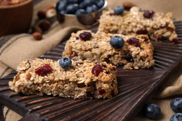 istock Tasty granola bars with berries on table, closeup 1940412406