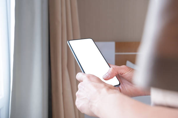 istock closeup of female hands using smartphone, white blank screen for mockup 1940418645