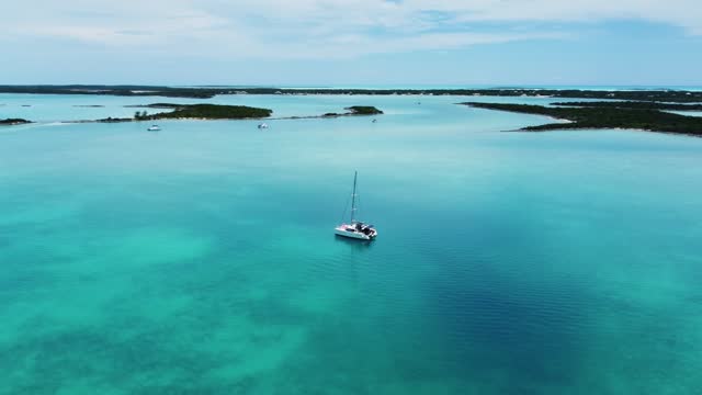 Beautiful Aerial View of the Exumas, Bahamas near George Town with many boats and Sailing Yachts Anchored. White sandy beach and turquoise Water.