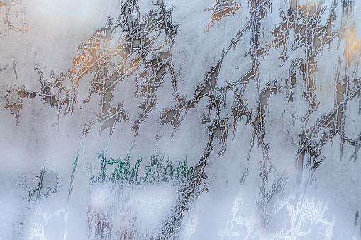 Ice background. Copy space. Frost pattern on glass. Cold weather.