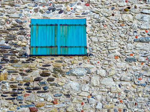 Barred basement window of an old building close up