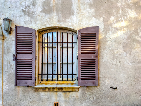 Close up window with shutter from old house in St Tropez, France