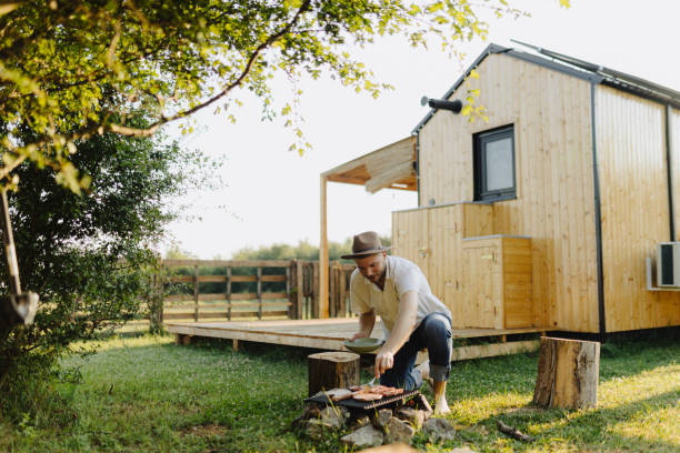 istock Young handsome man making barbecue at his backyard 1940463628