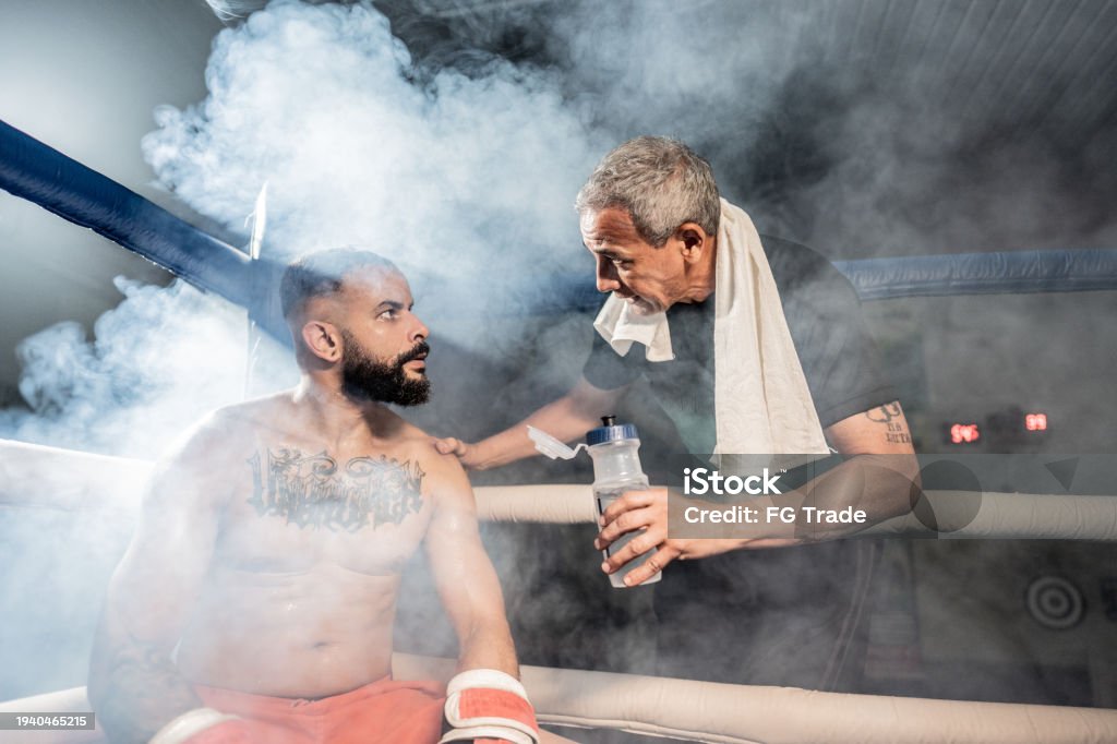 Boxing Coach Break Boxing Coach Instructing The Boxer On A Boxing Ring Stock Photo ...
