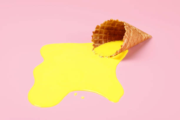 istock Melted ice cream and wafer cone on pink background 1940486327