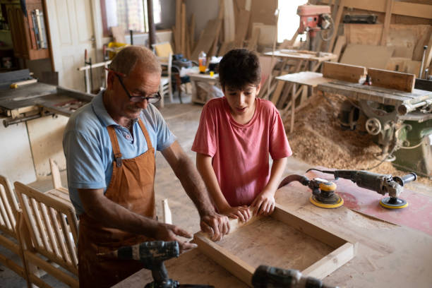 istock Grandfather and grandson in workshop 1940488538
