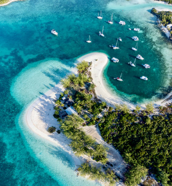 beautiful aerial view of famous chat'n'chill conch bar in stocking island (exuma - bahamas) near george town with many boats and sailing yachts anchored - caribbean sea fotografías e imágenes de stock