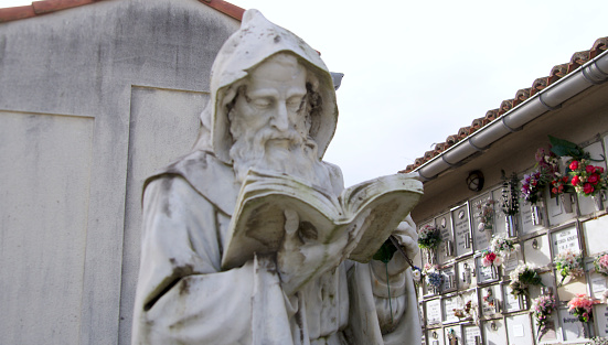 sculpture of holy man at reading time