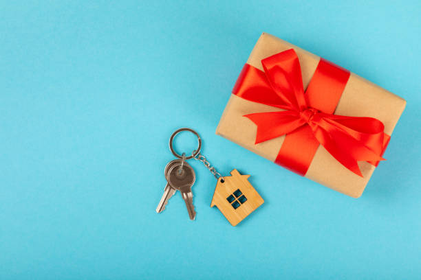 istock Keychain with key ring isolated on a colored background. Concepts for real estate and moving home or renting property. Buying a property. Mock-up keychain.Copy space. 1940534546