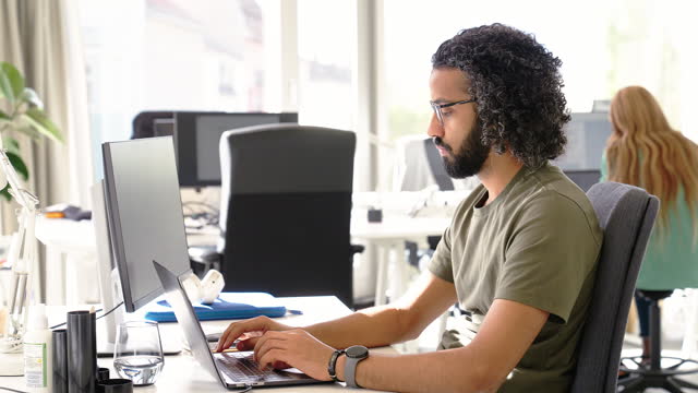 Man working on computer at startup office