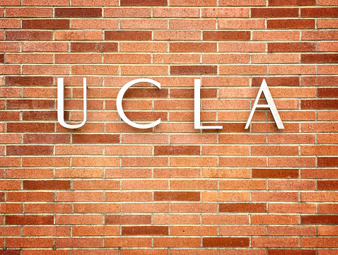 Sign on a brick wall at the entrance to UCLA, the University of California, Los Angeles, in Westwood