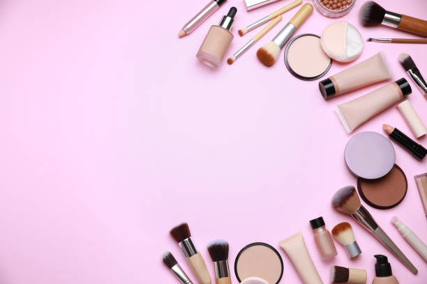 istock Face powders and other decorative cosmetic products on pink background, flat lay. Space for text 1940611273