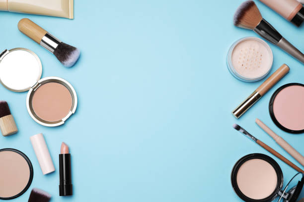 istock Face powders and other decorative cosmetic products on light blue background, flat lay. Space for text 1940615637