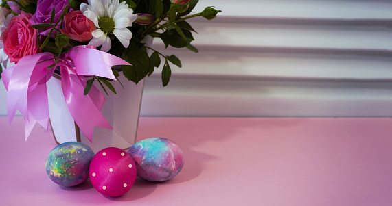 Happy easter! Flat Lay, postcard or Internet banner with Copy Space on Easter.  Bouquet of flowers and Easter eggs
