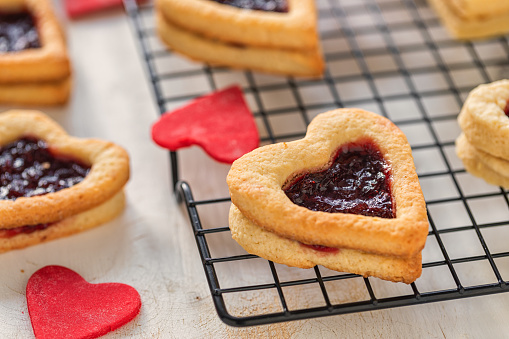 Glazed heart shaped cookies for Valentine's day - delicious homemade natural organic pastry, baking with love for Valentine's day, love concept