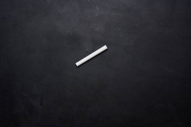 istock Empty chalk board and piece of white chalk 1940682464
