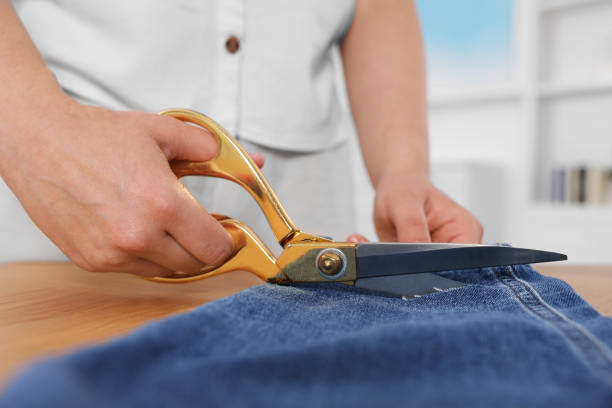 istock Woman making ripped jeans at table, closeup 1940699528