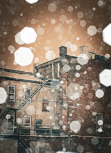 Abandon building while snowing with blurry snowflakes bokeh effect