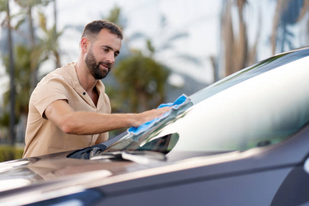 istock Man cleaning his car using micro fiber cloth. Car washing service concept 1940717157