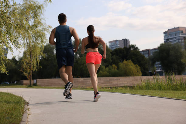 Healthy lifestyle. Couple running outdoors, low angle view