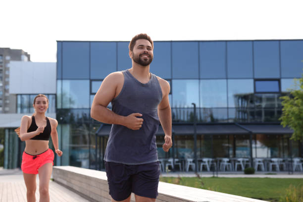 istock Healthy lifestyle. Happy couple running outdoors. Space for text 1940728962