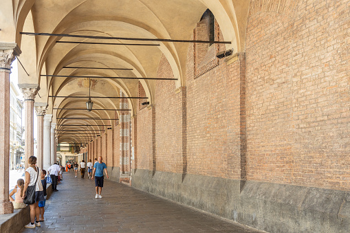 Padova, Veneto, Italy - Jun 25th, 2023: People walking by doorway of Santa Maria dei Servi Church, in Padua city center