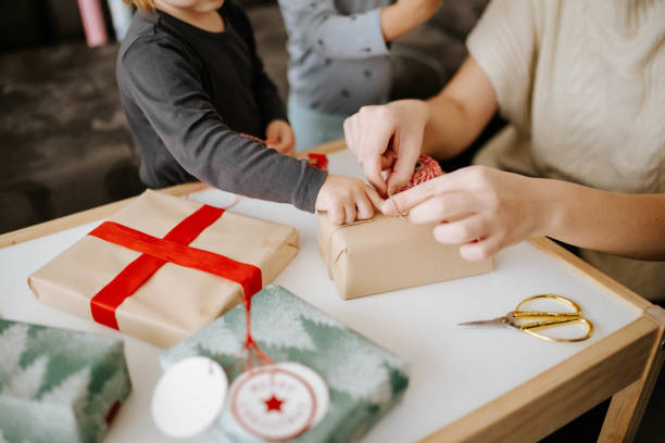 istock Family wrapping presents for Christmas together 1940753339