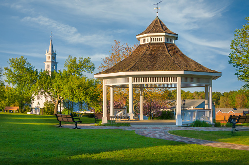 The town bandstand and village church in the center of Norfolk, Massachusetts on a springtime late afternoon.