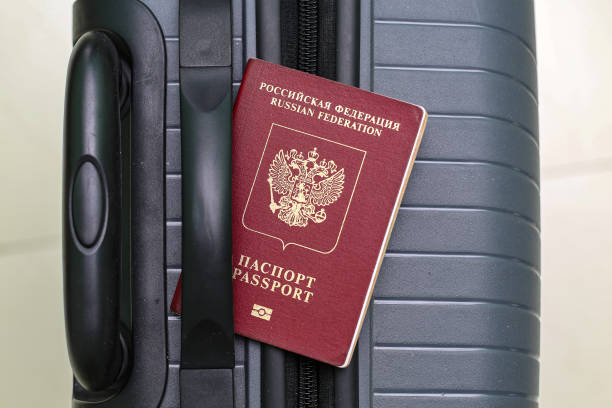 istock View of russian passport and grey suitcase. 1940772806