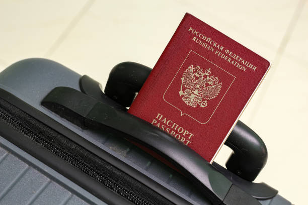 istock View of russian passport and grey suitcase. 1940773334