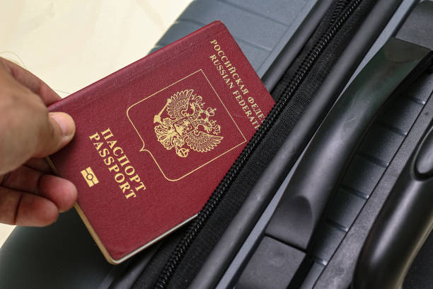 istock View of russian passport and grey suitcase. 1940774359