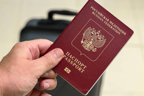 istock View of russian passport and grey suitcase. 1940774878