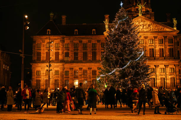 istock Christmas tree on Dam Square. Crowd of people on the middle-ground. 1940774910