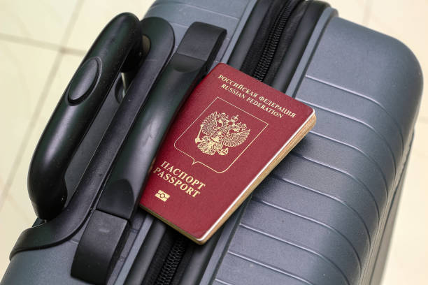 istock View of russian passport and grey suitcase. 1940775449