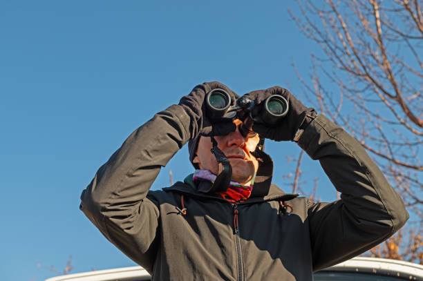 istock A man with binoculars bird watching on the lake. 1940790001