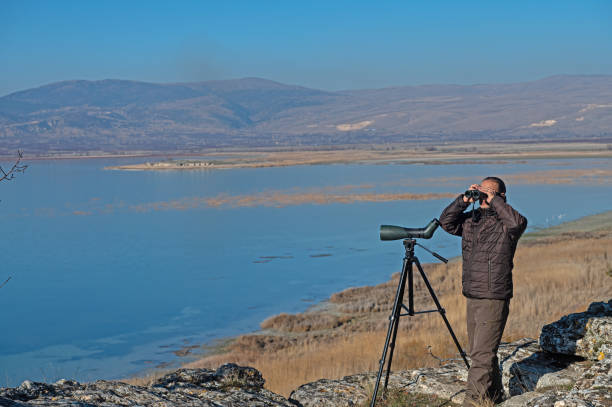 istock A man with binoculars bird watching on the lake. 1940791587